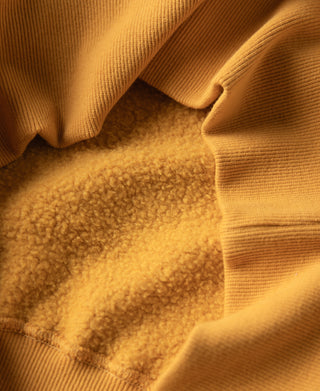 Yellow raglan sweatshirt collar seam detail, plush interior