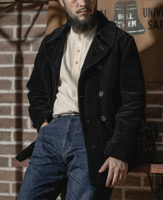 Apricot henley shirt with button placket and ribbed collar, worn under black coat
