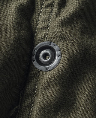 Olive field jacket drawstring grommet with snap button detail