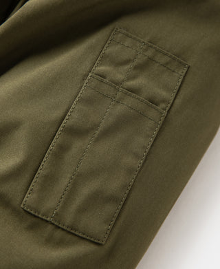 Olive parka front pocket with rectangular patch and topstitching