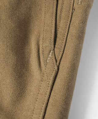 Khaki cotton canvas climbing pants, stitched seam close-up