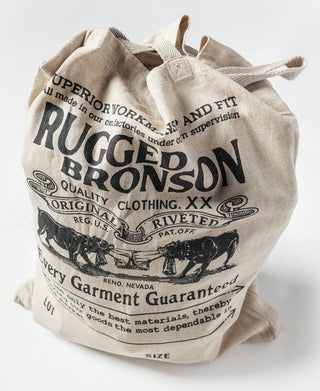 Natural linen tote bag front with printed RUGGED BRONSON and Every Garment Guaranteed.