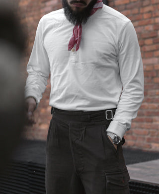 White long-sleeve henley shirt worn by a man with visible partial button placket