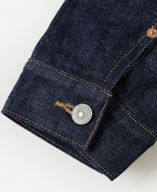 Denim jacket cuff with metal snap and plaid blanket lining