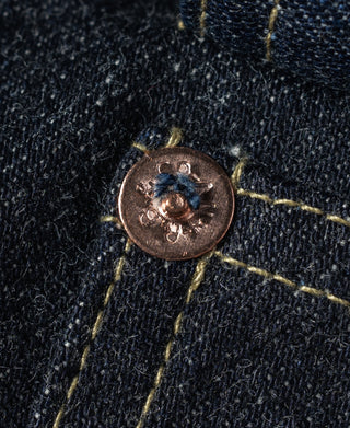 Indigo denim jacket button with copper-toned hardware