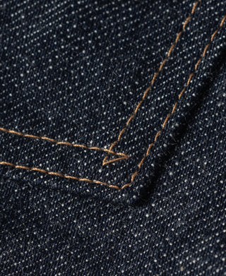 Indigo denim jacket stitched seam with reinforced cross-stitch detail