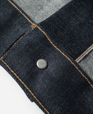 Indigo selvedge denim jacket stitched seam with round metal button detail