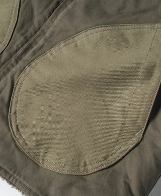 Olive vest close-up of rounded side pocket with reinforced stitched edge