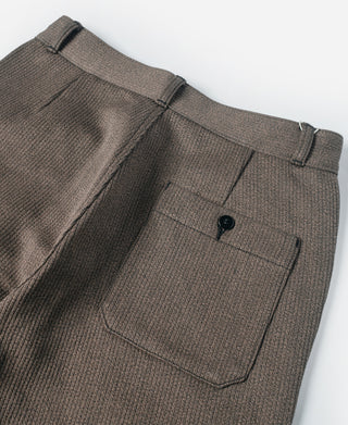 Brown striped pants front view with belt loops and dark button at waistband