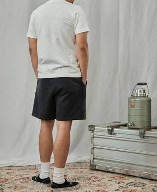 White crew-neck cotton t-shirt on model, short sleeves and ribbed-looking neckline