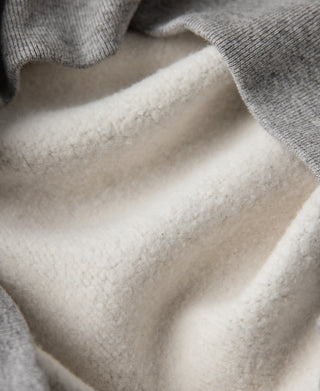 Gray sweater interior lining visible around inner V-neck opening