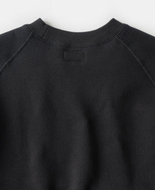 Black raglan crewneck sweatshirt with ribbed collar and shoulder seam details
