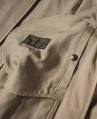Khaki summer flight jacket sleeve with snap pocket and black zipper trim