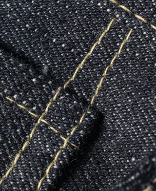 Indigo denim jeans close-up of bar-tack stitching on a seam