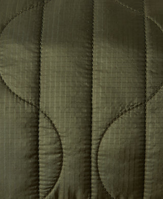 Olive quilted waist bag panel with vertical seam stitching and curved edges