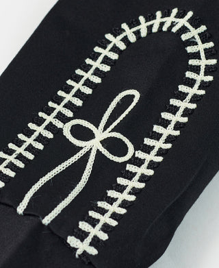 Black jacket with cream embroidered treble bow motif and cross-stitch border