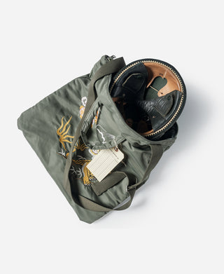 Olive embroidered helmet bag open with zipper and interior items