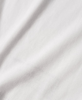 White cotton tank top fabric close-up showing smooth knit texture