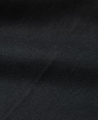 Black work pants fabric close-up with fine woven texture