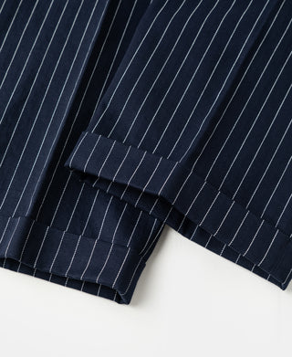 Navy pinstripe work pants hem with stitched cuff and belt-loop waistband