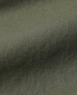 Olive textured fabric close-up with fine weave for bermuda shorts