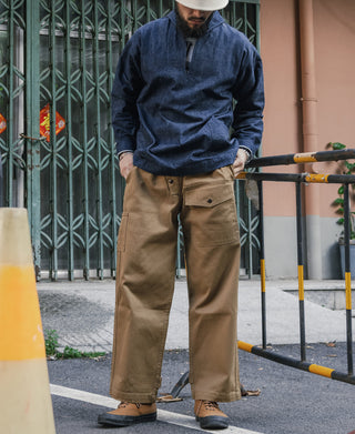 Indigo dungaree pullover jumper with zip-front, worn with tan work trousers