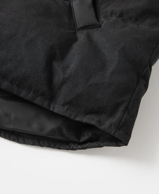 Black quilted vest side panel with curved hem and stitched padding.