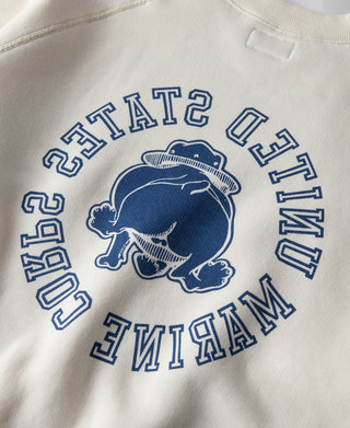 White raglan sweatshirt with blue “United States Marine Corps” devil dog graphic.