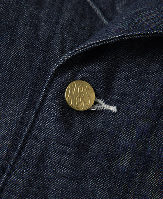 Indigo denim jacket button closure with round gold snap and keyhole bar