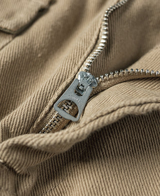Khaki cotton twill pants zipper fly with metal zipper pull detail.