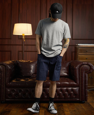 Navy P-44 utility shorts worn with dark cap and sneakers