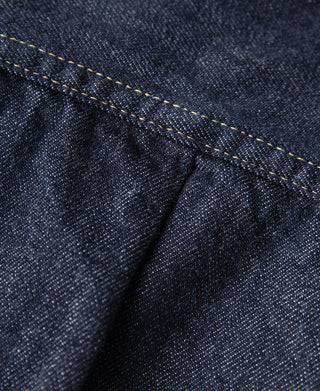 Indigo denim jacket fabric with pleats and contrast yellow topstitching