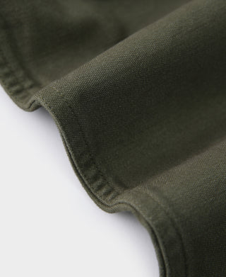 Olive fatigue utility shirt sleeve hem with stitched edge and fabric texture