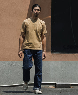Khaki cotton henley T-shirt on a model, short sleeves and button placket visible
