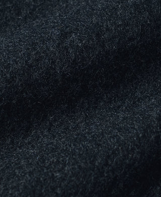 Dark salt-and-pepper wool fabric texture with fine speckled flecks