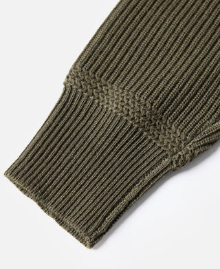 Olive wool sweater sleeve cuff with ribbed knit finish