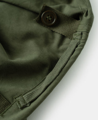 Olive shell arctic trousers, rounded button and stitched cuff detail