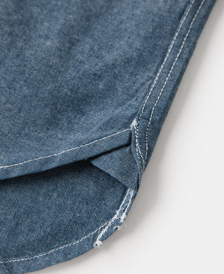 Blue chambray work shirt hem with contrast stitching and reinforced corner