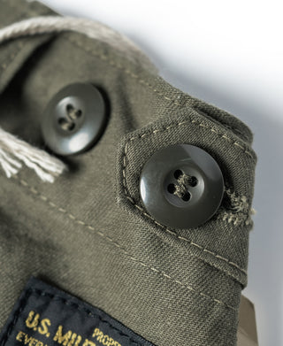 Olive fatigue utility shorts with button closure and branded pocket label