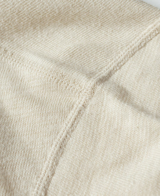 Cream knit sleeve and hem with stitched seam detail