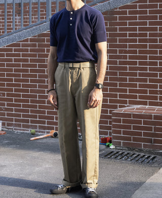 Khaki straight-leg work pants with belt loops, button fly, and side pockets