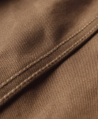Khaki canvas hunting vest side seam with visible topstitching