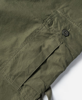 Olive fatigue pants with button closure and diagonal front pocket flap
