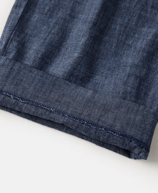 Indigo chambray pants hem with stitched cuff edge and hemline seams