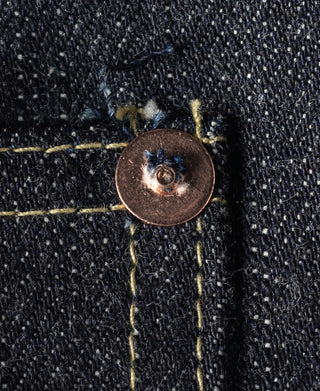 Indigo denim jacket copper button attached to stitched detail