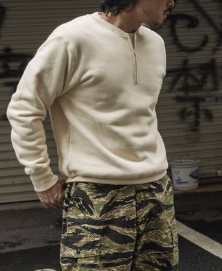 Apricot half-zip fleece sweatshirt worn by a model, long sleeves and front zip