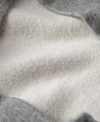 Gray raglan-sleeve sweater interior, soft knit lining detail
