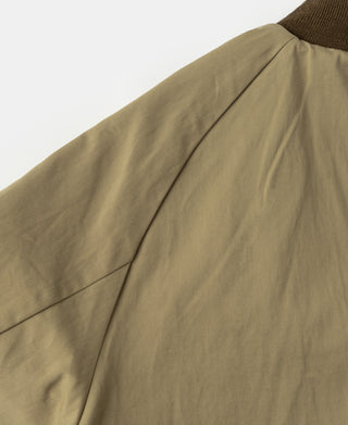 Brown bomber jacket shoulder and sleeve seam with smooth outer panel