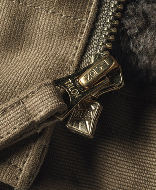 Khaki jacket zipper pull with metal hardware and dark gray lining