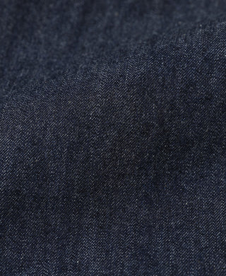 Indigo denim fabric close-up with speckled texture